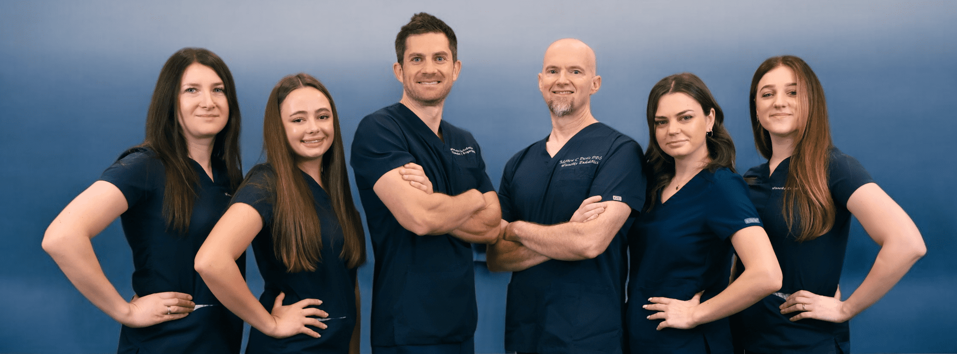 the doctors and staff in front of a blue background